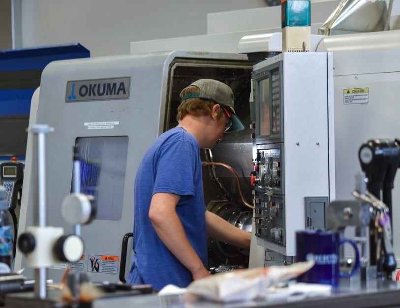 CNC machinist finishes a setup on a Swiss type lathe