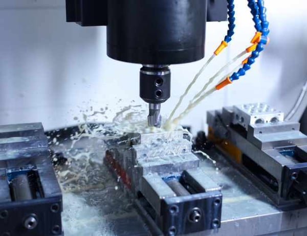 Coolant being sprayed onto workpiece in between milling operations