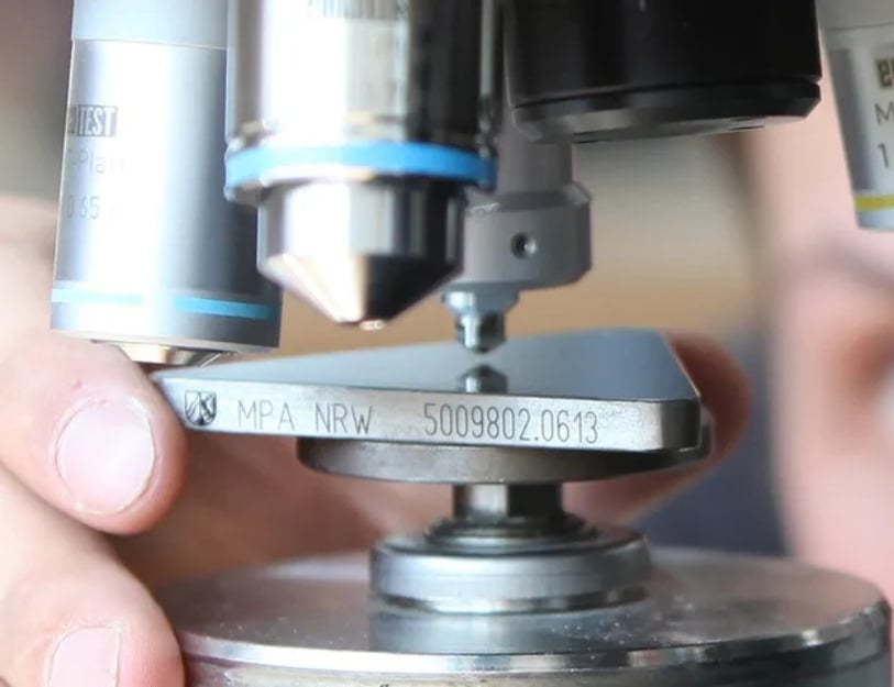 Machinist tests an aluminum plate's hardness