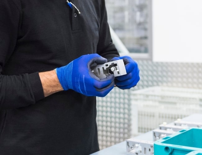 Assembly specialist handles a stainless steel component