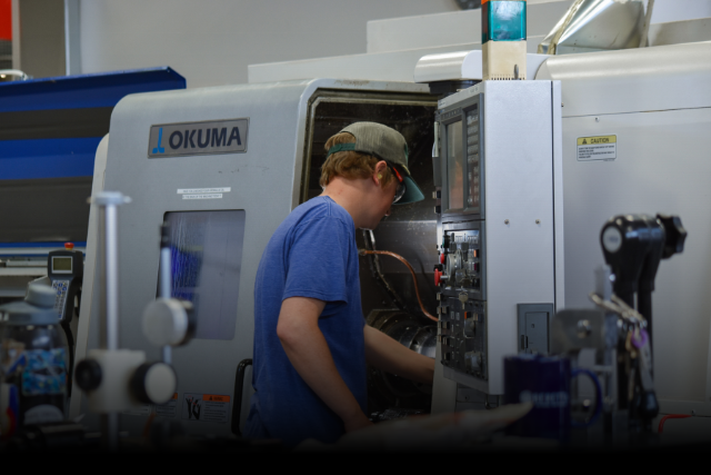 CNC machinist loads parts onto lathe