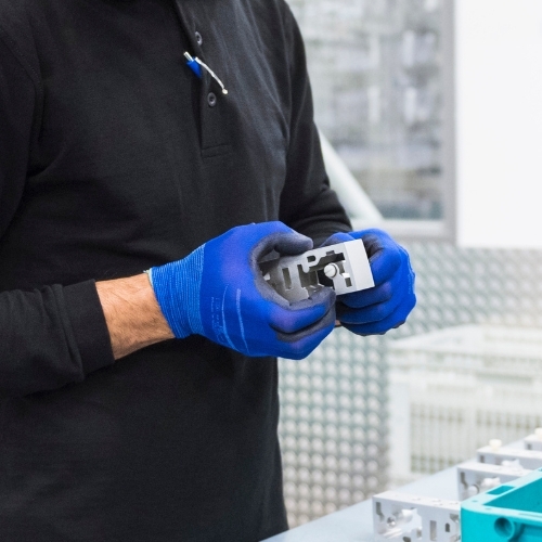Assembly specialist handles a stainless steel part