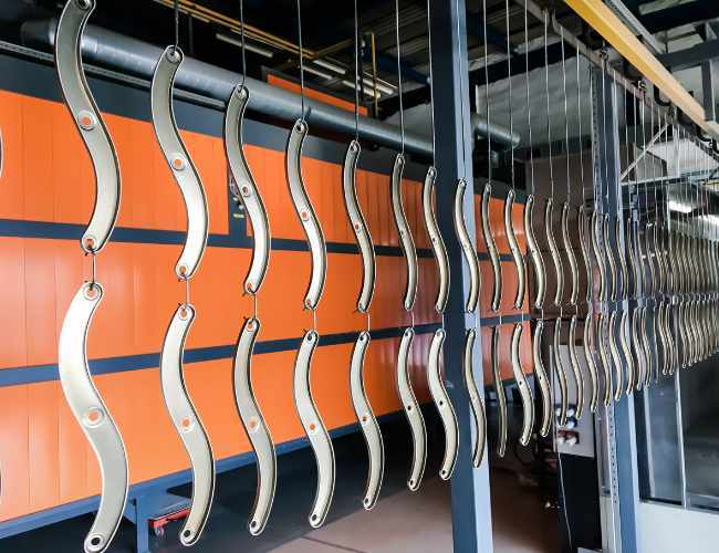 Aluminum parts hang on anodizing racks